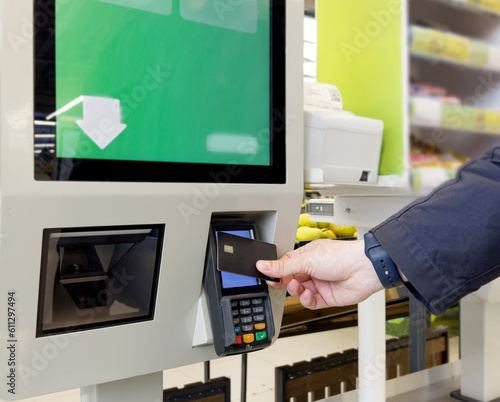 Customer pays his purchase at the supermarket,self checkout systems in retail stores,Barcode scanner,Self checkout machine