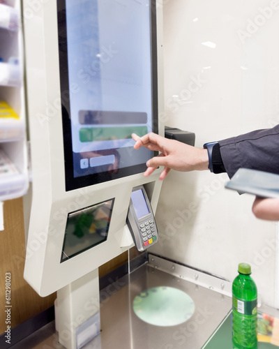 Customer pays his purchase at the supermarket,self checkout systems in retail stores,Barcode scanner,Self checkout machine