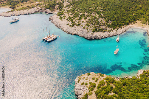 Sailing yachts in Akvaryum koyu lagoon with crystal water in Bodrum Turkey, Aerial view