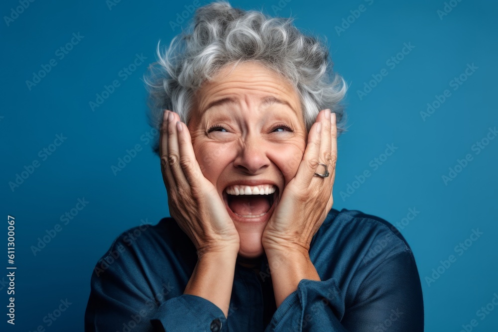 Headshot portrait photography of a joyful mature woman putting hands on the face in a gesture of terror against a sky-blue background. With generative AI technology Headshot portrait photography of a joyful mature woman putting hands on the face in a gesture of terror against a sky-blue background. With generative AI technology