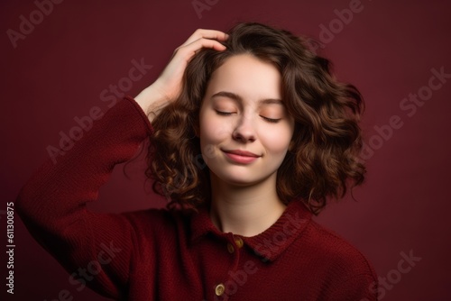 Headshot portrait photography of a glad girl in her 20s holding the hand on the forehead in a headache gesture against a burgundy red background. With generative AI technology