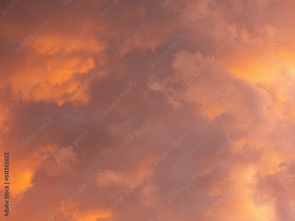 Dramatic sky with clouds. Mysterious abstract background pattern texture. Many yellow and orange tones and patterns of clouds.