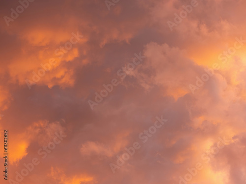 Dramatic sky with clouds. Mysterious abstract background pattern texture. Many yellow and orange tones and patterns of clouds.