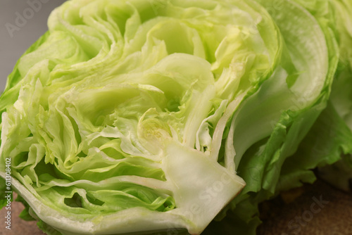 Half of fresh green iceberg lettuce head on table  closeup