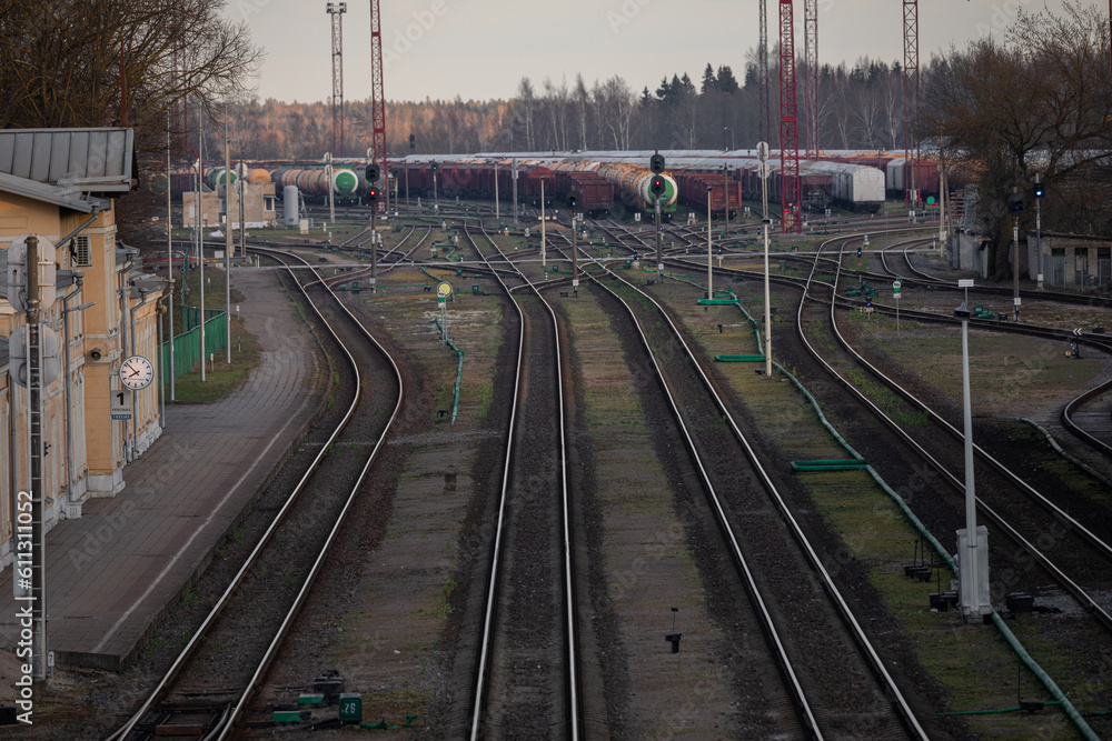 Obraz premium Railway Network In Lithuania. Radviliskis is well known railway capital in Lithuania. Beautiful evening sunset light and cars in background.