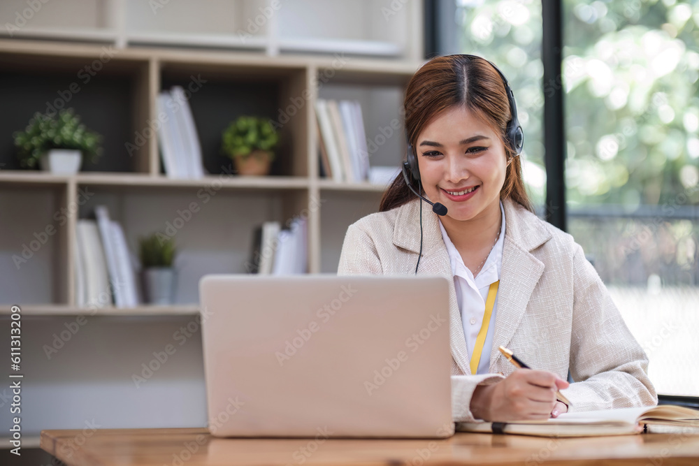 Asian call center with headset and microphone working on her laptop. Female operator provide exceptional customer service. Supportive call center agent helping customer on inquiry. Enthusiastic Asian call center with headset and microphone working on her laptop. Female operator provide exceptional customer service. Supportive call center agent helping customer on inquiry. Enthusiastic