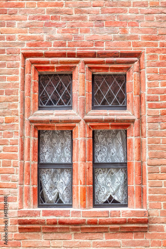 Window at red brick wall