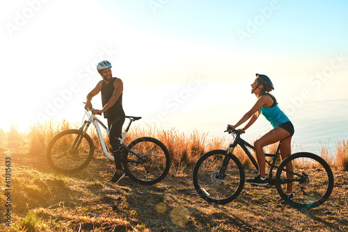 Happy couple, workout and cycling in the mountains for fitness and exercise together. Bike, wellness and young people with outdoor adventure and sports training with happiness and freedom mockup