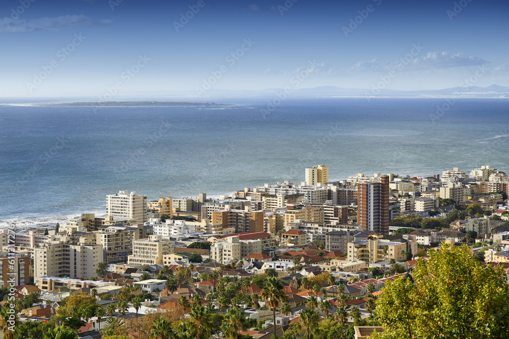 City, ocean and urban buildings with architecture, infrastructure and development for property expansion. Skyline, metro cbd and outdoor with cityscape, skyscraper and sea with space in Cape Town