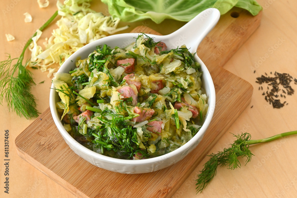 Stewed young cabbage with dill and sausage