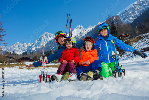 Happy ski vacation with kids mom and children cheer lift hands