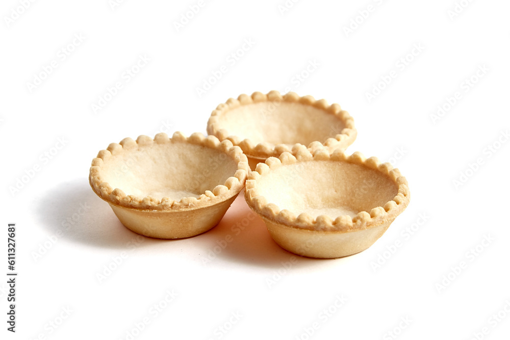 Tartlet shells isolated on white background. Three empty mini tart shells for portable desserts Tartlet shells isolated on white background. Three empty mini tart shells for portable desserts