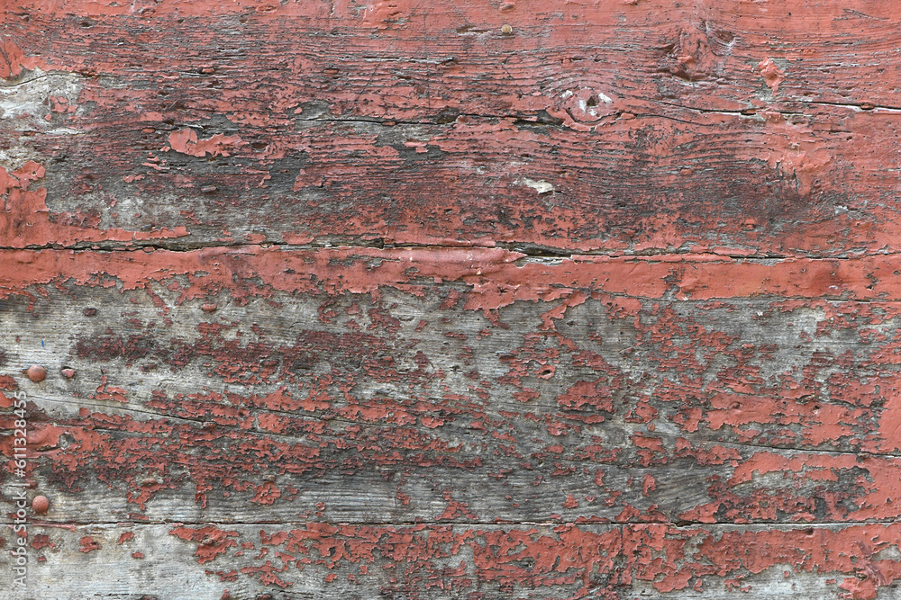 Old scratched wood abstract background - old red color painted weathered wooden plank