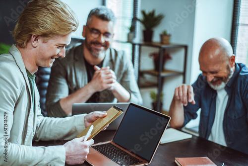 Φωτογραφία Happy business team sits together in office, engaged in lively conversation