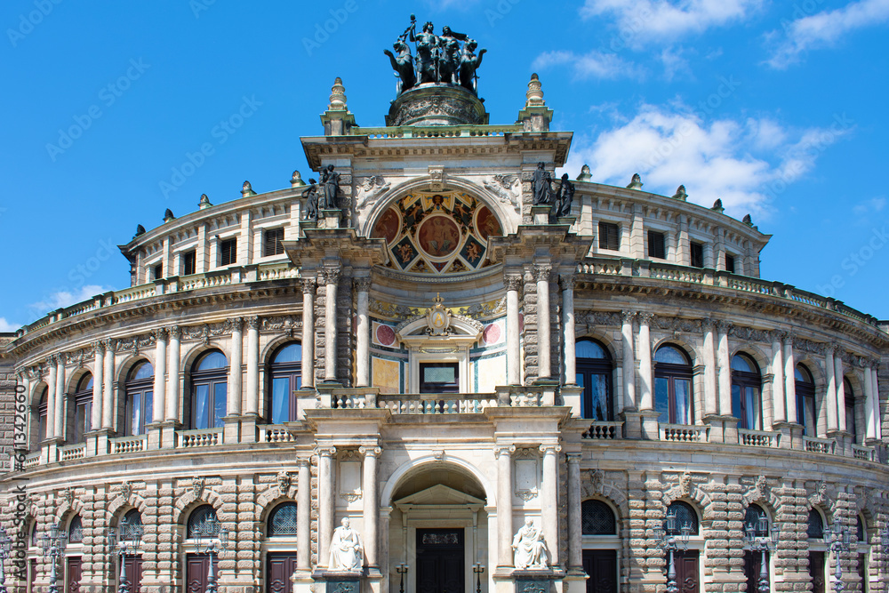 Facade of ancient architectural building with beige walls, statues, decorative elements, semicircular windows and arch. Historical architecture. Old town. Opera House. Dresden, Germany, May 2023 