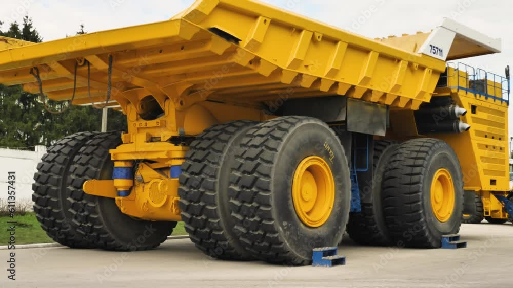 The largest dump truck in the world by a Belarusian manufacturer of mining equipment. A total of 4 such dump trucks have been produced. A huge yellow truck. Panorama from left to right