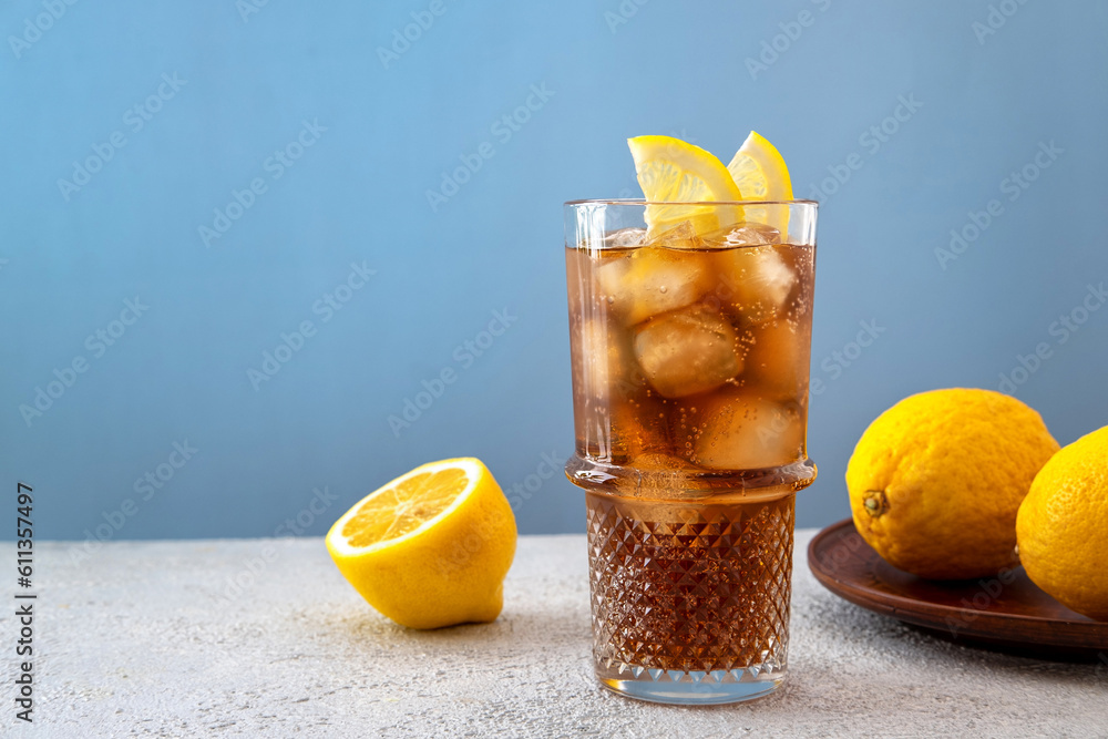 Long Island iced tea cocktail garnished with lemon slice in highball