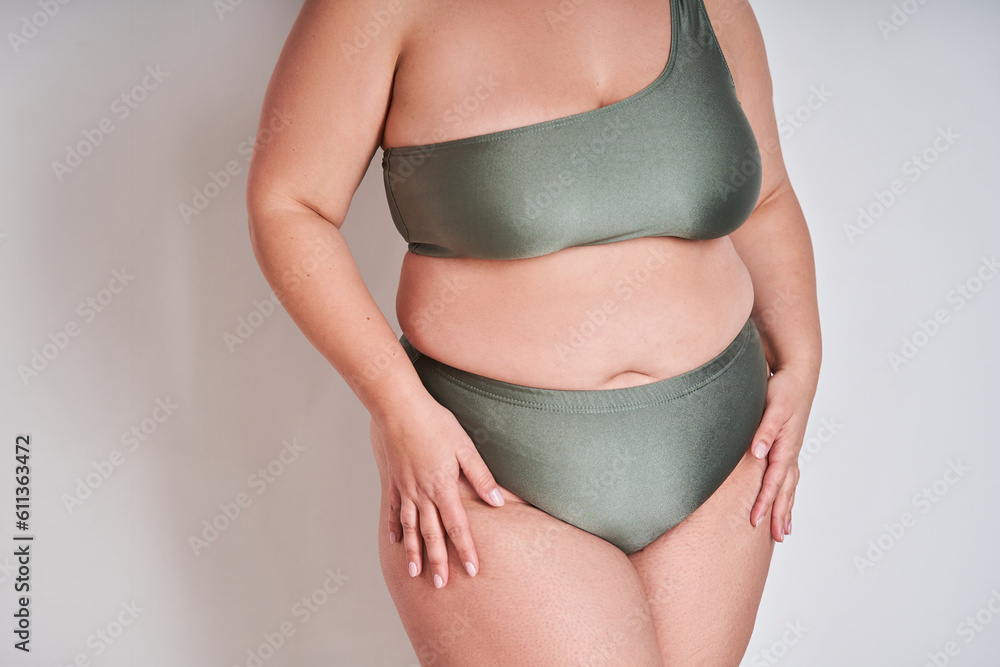 Studio close up shot of confident natural woman in underwear promoting body positivity