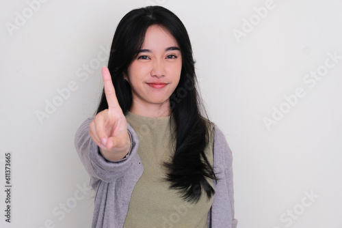 Young Asian woman doing No finger sign photo