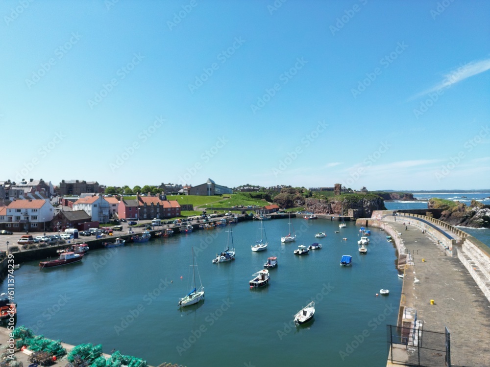 Aerial view of Dunbar harbour with boats docked and a clear blue sky background. Dunbar Scotland. 