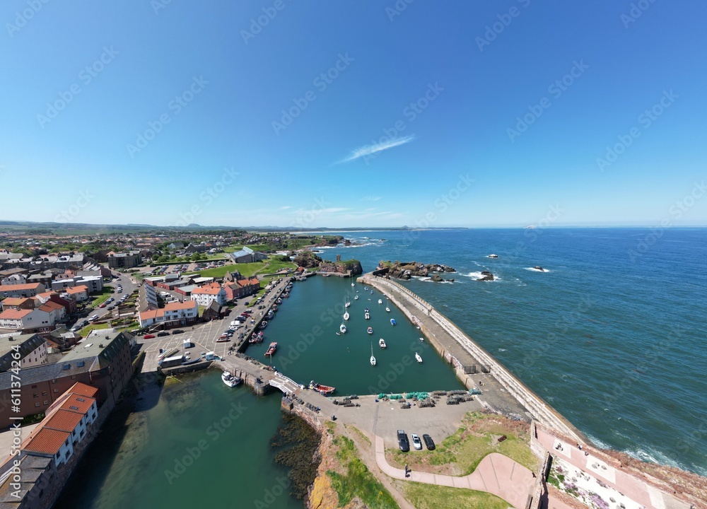 Aerial view of Dunbar harbour with boats docked and a clear blue sky background. Dunbar Scotland. 