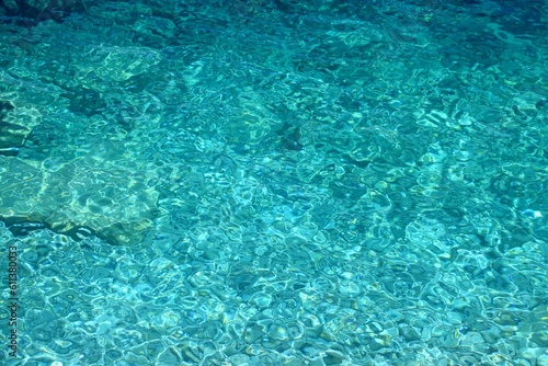 Summer water texture. Adriatic Sea. Turquoise or aqua colored water abstract. © Tupungato