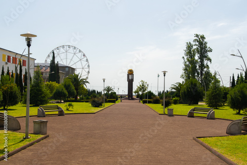 A tall Ferris wheel in a city park