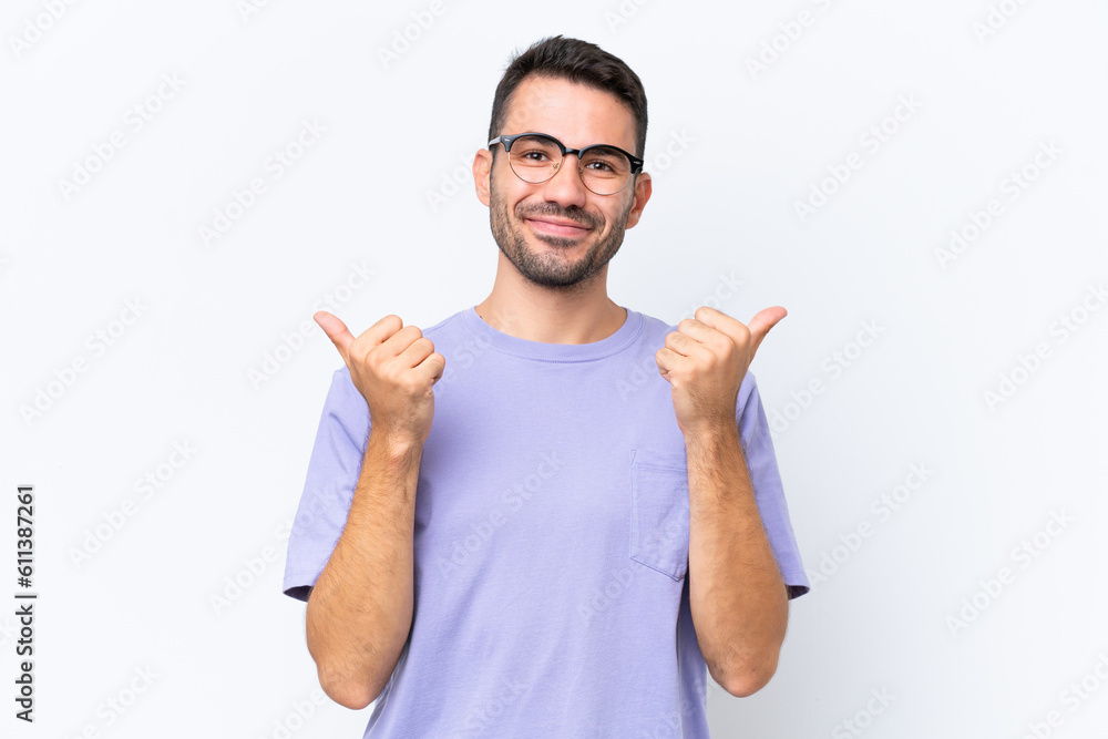 Young caucasian man isolated on white background with thumbs up gesture and smiling Young caucasian man isolated on white background with thumbs up gesture and smiling