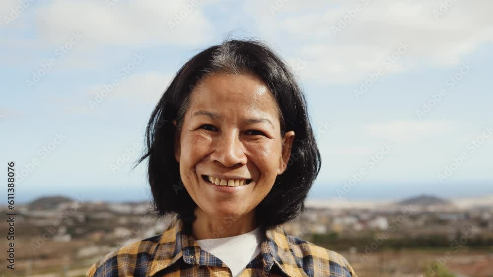 Happy Thai woman having fun having fun smiling into the camera at house rooftop Happy Thai woman having fun having fun smiling into the camera at house rooftop