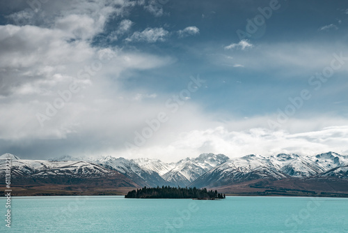 Scenic view of Lake Tekapo east bank. Beautiful view driving along the Lilybank Road from Lake Tekapo Park towards Motuariki View Point. Motuariki island can be seen from the view point. photo