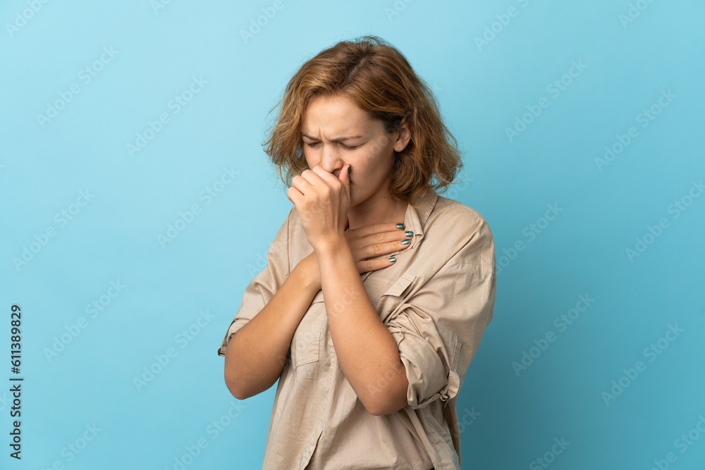 Young Georgian woman isolated on blue background is suffering with cough and feeling bad Young Georgian woman isolated on blue background is suffering with cough and feeling bad