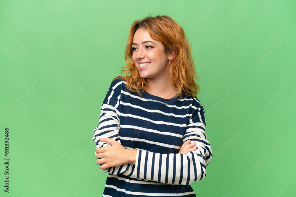 Young caucasian woman isolated on green screen chroma key background looking to the side and smiling Young caucasian woman isolated on green screen chroma key background looking to the side and smiling