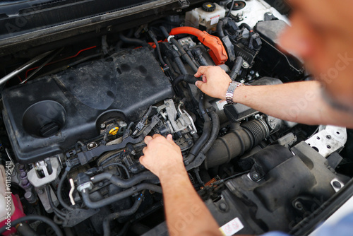 male mechanics hands check electrical wiring vehicle system in a car service © Olga