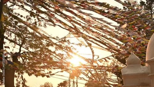 The prayer flags hanging and blowing by the wind during sunset.