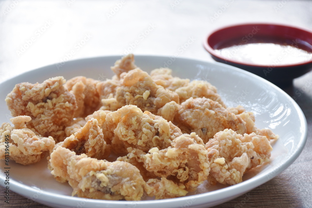 crispy fried Korean chicken with bread crumb and egg yolk on plate dipping barbecue sauce crispy fried Korean chicken with bread crumb and egg yolk on plate dipping barbecue sauce