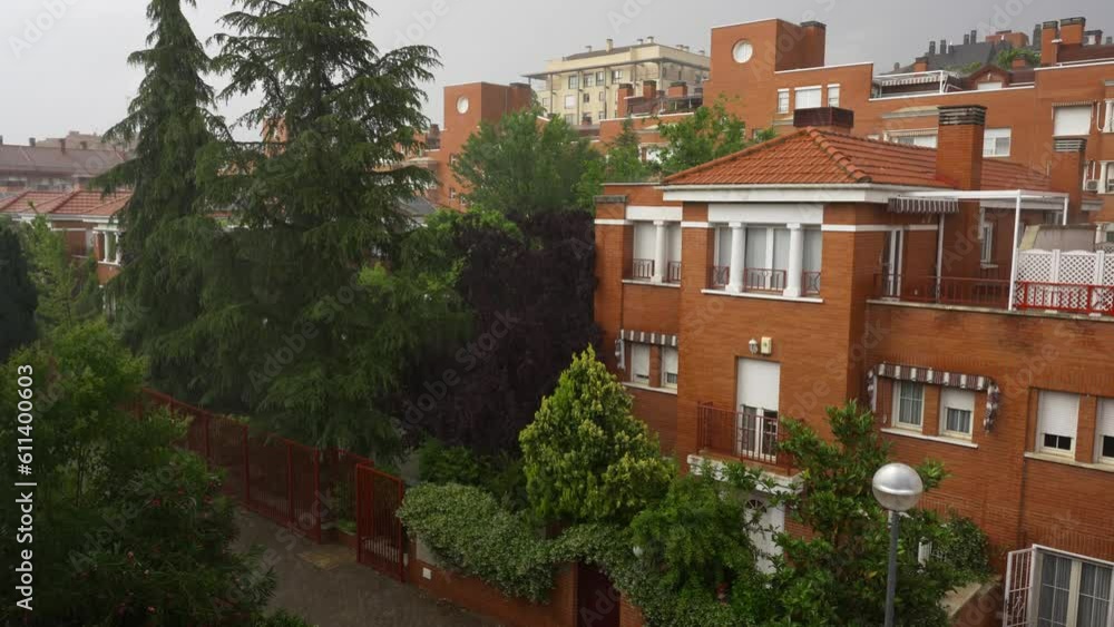It rains heavily on the city falling water on buildings and trees. It rains heavily on the city falling water on buildings and trees.