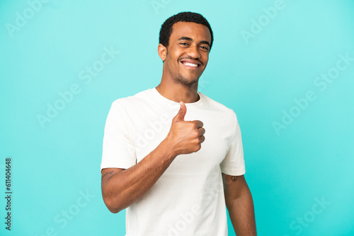 African American handsome man on isolated blue background giving a thumbs up gesture