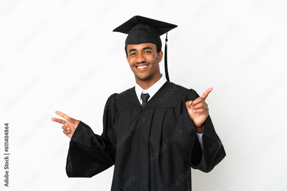 African American university graduate man over isolated white background pointing finger to the laterals and happy African American university graduate man over isolated white background pointing finger to the laterals and happy