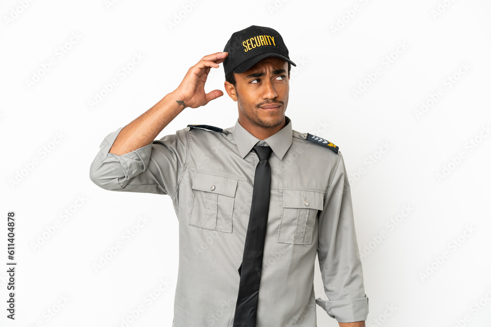 African American safeguard over isolated white background having doubts and with confuse face expression African American safeguard over isolated white background having doubts and with confuse face expression