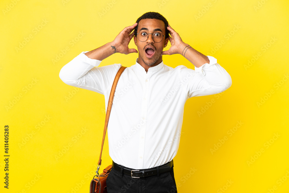 African American business man over isolated yellow background with surprise expression African American business man over isolated yellow background with surprise expression