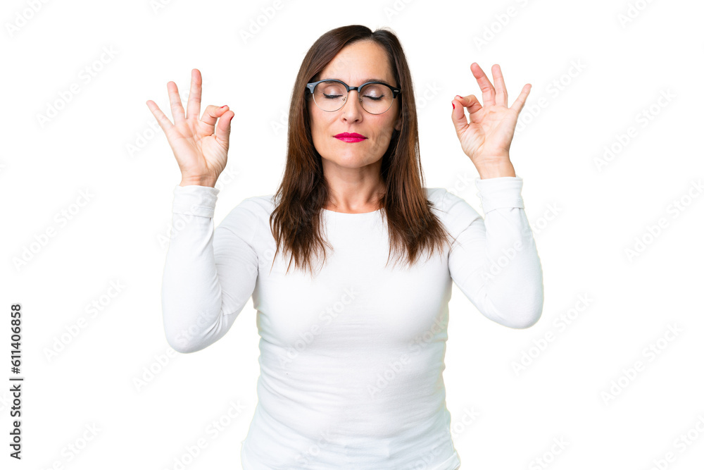 Middle age woman over isolated chroma key background in zen pose Middle age woman over isolated chroma key background in zen pose