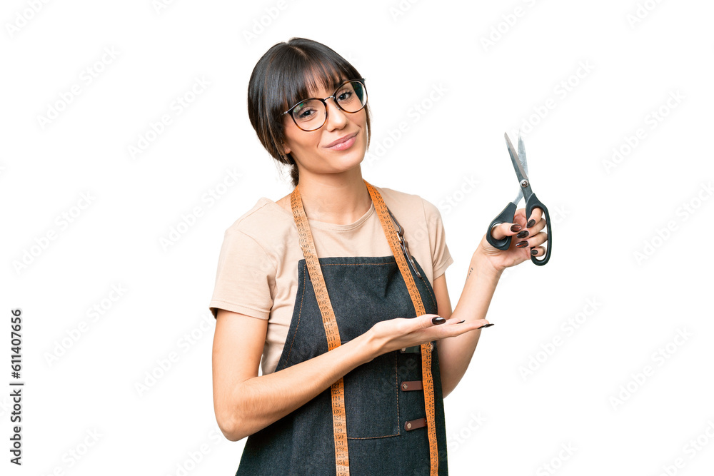 Young caucasian seamstress over isolated on chroma key background extending hands to the side for inviting to come Young caucasian seamstress over isolated on chroma key background extending hands to the side for inviting to come
