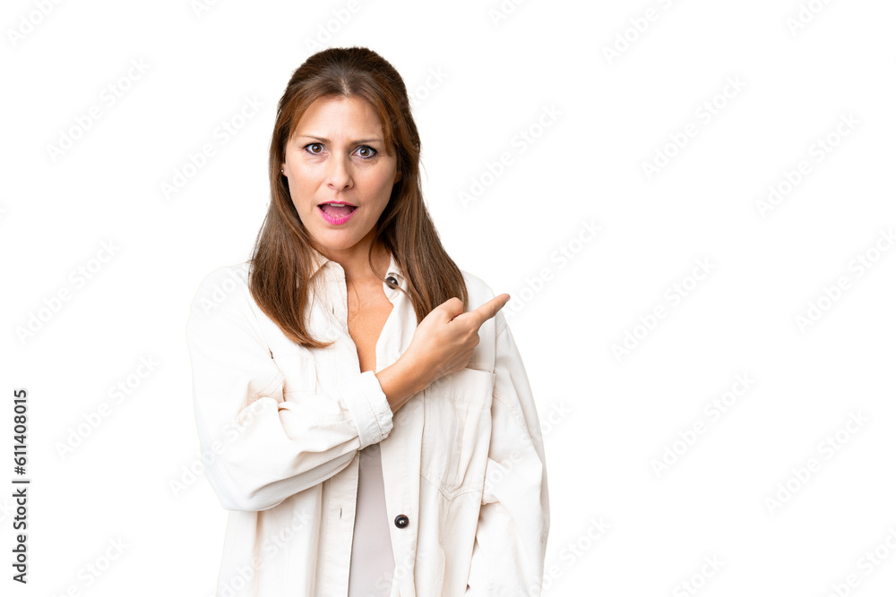 Middle age woman over isolated background surprised and pointing side Middle age woman over isolated background surprised and pointing side