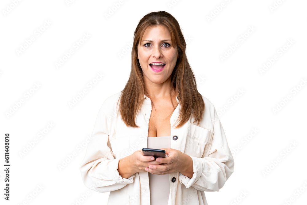 Middle age woman over isolated background surprised and sending a message Middle age woman over isolated background surprised and sending a message