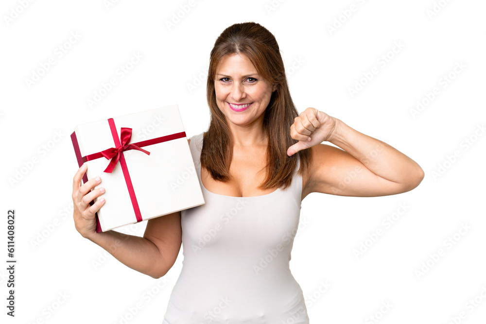Middle age caucasian woman holding a gift over isolated background proud and self-satisfied Middle age caucasian woman holding a gift over isolated background proud and self-satisfied