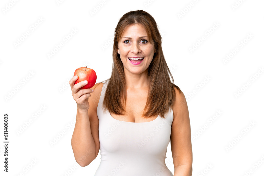 Middle age woman with an apple over isolated background with surprise and shocked facial expression Middle age woman with an apple over isolated background with surprise and shocked facial expression