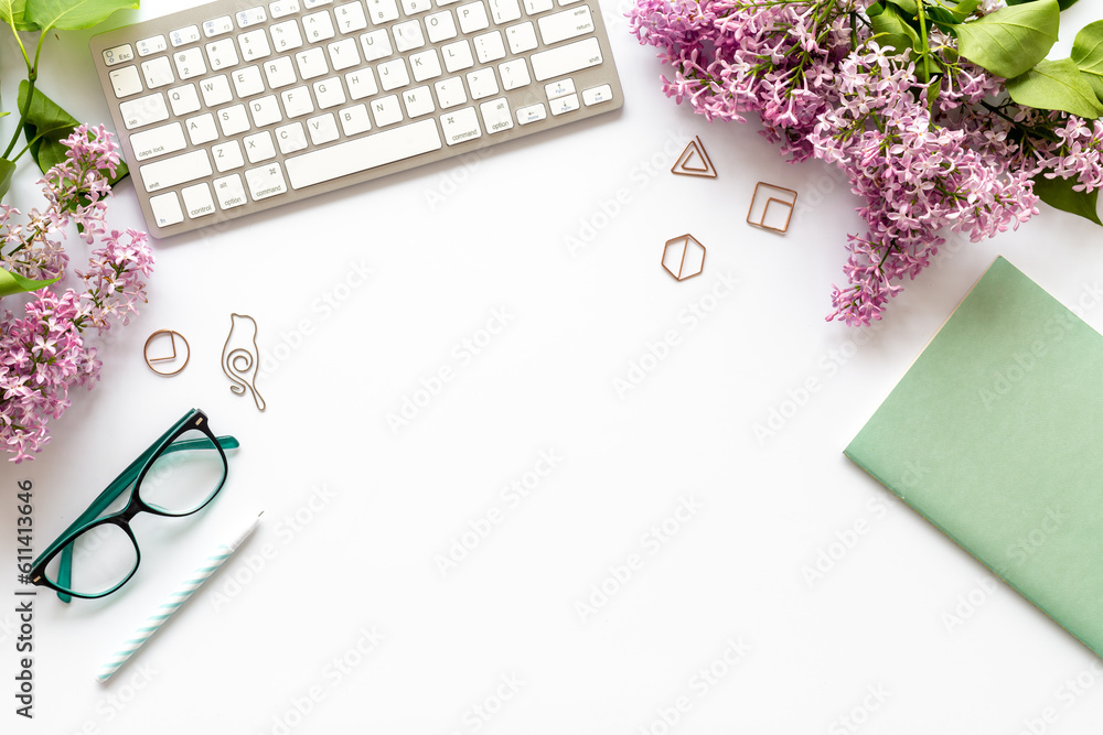 Top view of beautiful desktop with computer and spring flowers bouquet Top view of beautiful desktop with computer and spring flowers bouquet
