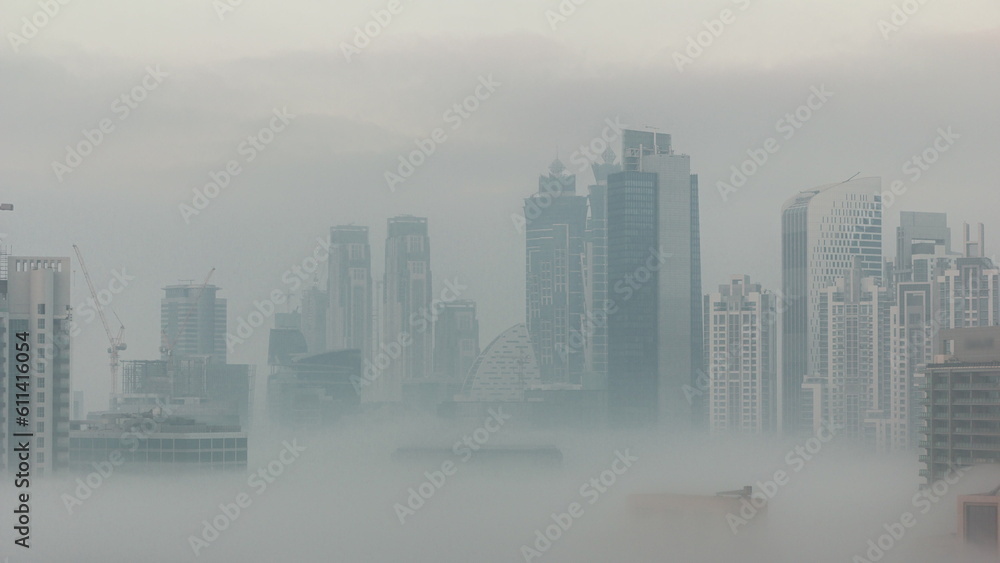 Obraz premium Dubai skyscrapers with morning fog in business bay district night to day timelapse.