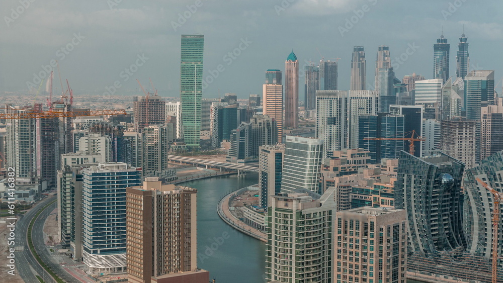 Fototapeta premium Skyline with modern architecture of Dubai business bay towers morning timelapse. Aerial view