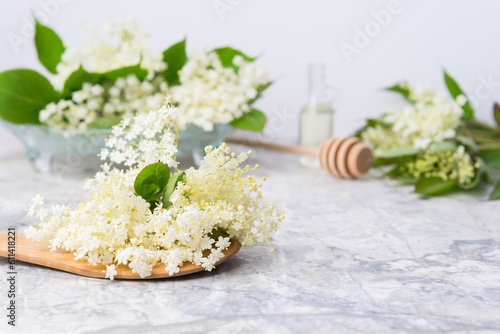 composition of elderberry flowers on a table on a light background 